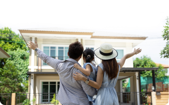 family standing in front of their new home purchase